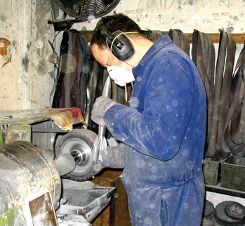 Dressing the casting on a linishing wheel, to remove split lines and feeder witnesses